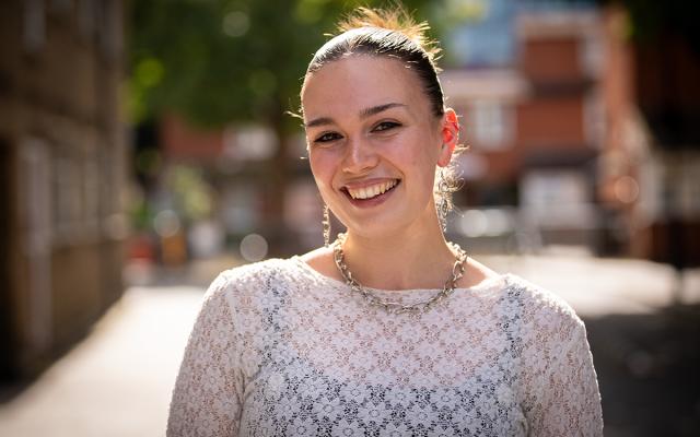 Emily Clark, Philharmonia Instrumental Fellow, smiling at the camera outside Philharmonia office