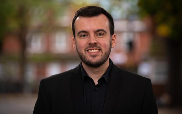 Ewan smiling at camera outside Philharmonia office