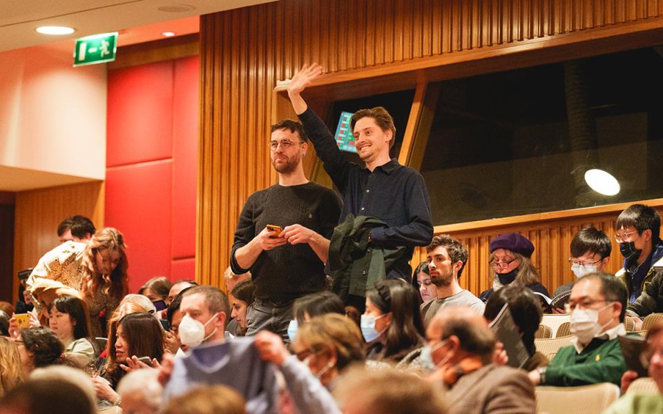 Two Audience Members Waving