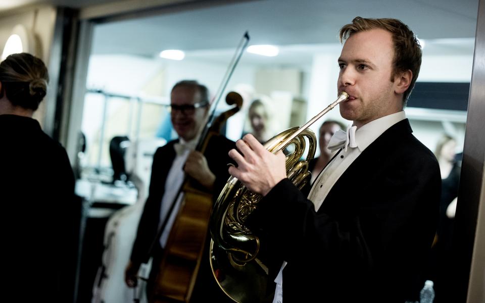 Jonathan Maloney practising the horn backstage